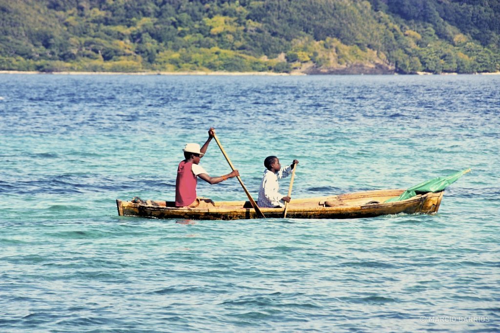 A couple of garifuna boys with a canoe