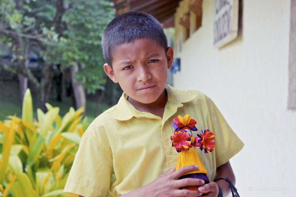 Mayan boy selling typical handmade dolls